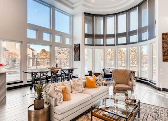 A living room with a large couch and a fireplace.