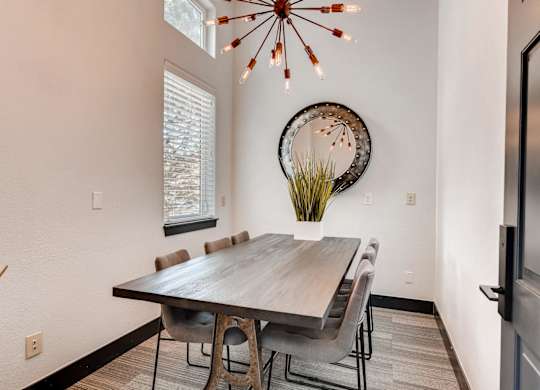 A dining room with a wooden table and chairs.