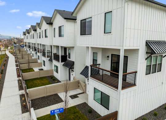 Apartment complex with white buildings and balconies.