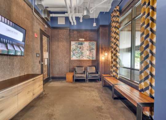A room with a wooden bench and a television on the wall.