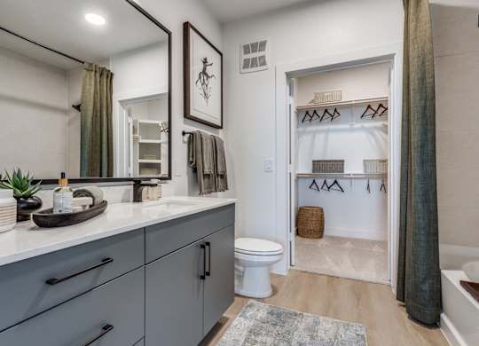 A bathroom with a white toilet and a white sink.