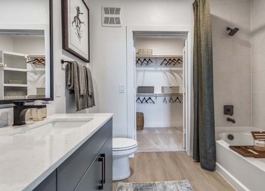 A bathroom with a white tub and a white toilet.