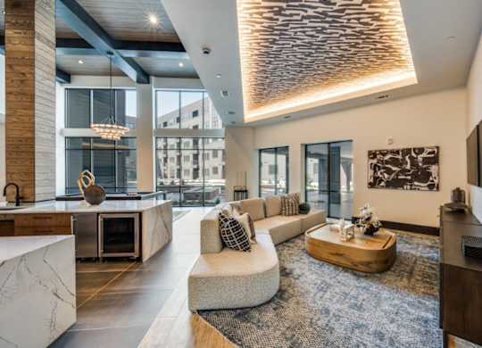 A modern living room with a large window and a wooden floor.