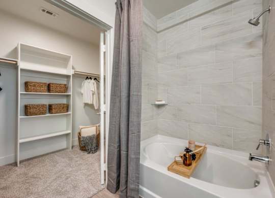 A bathroom with a tub and a walk-in shower.