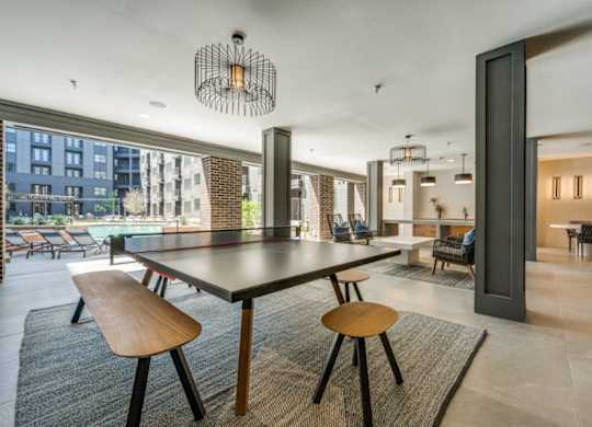 A modern dining room with a large table and chairs.