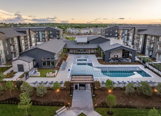 an aerial view of an apartment complex with a swimming pool