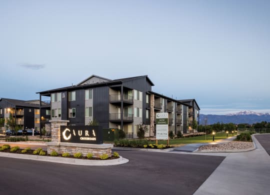 a large apartment building with a sign in front of it