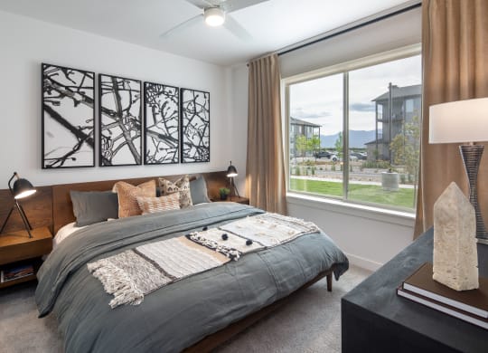 a bedroom with a bed and a large window