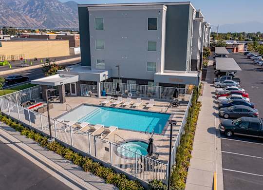 A modern building with a pool in front.