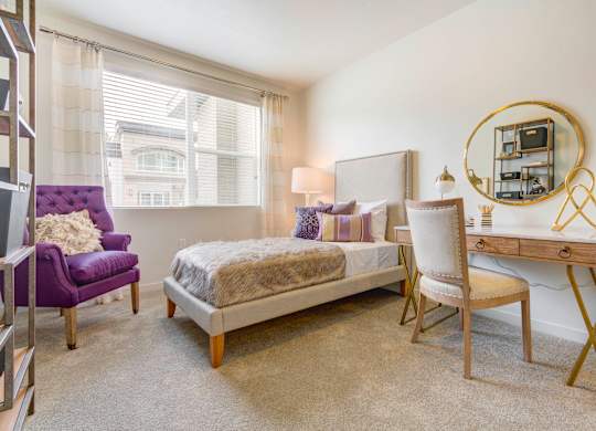 a bedroom with a bed and a desk