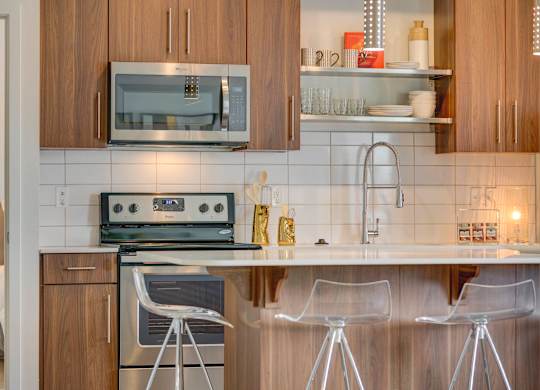 a kitchen with white tile and wooden cabinets