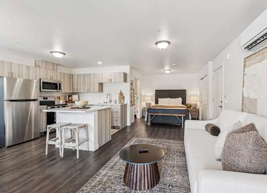 A modern kitchen with a white couch and a coffee table.
