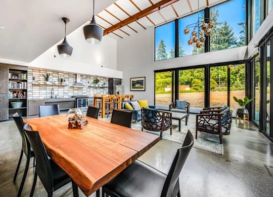 A modern dining room with a wooden table and chairs.