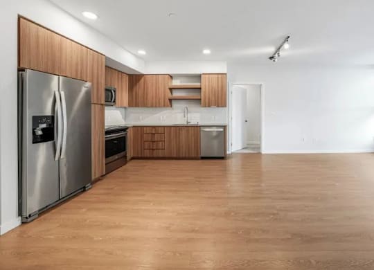 A kitchen with wooden floors and stainless steel appliances.
