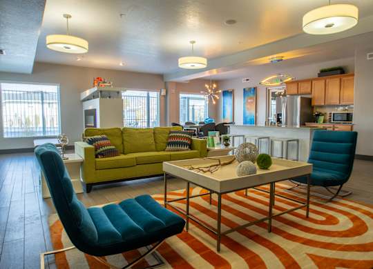 A modern living room with a green couch and a blue chair.