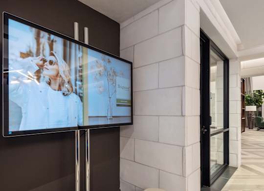 A modern living room with a flat screen TV mounted on the wall.