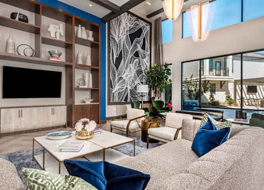 A living room with a grey couch, a coffee table, and a TV.