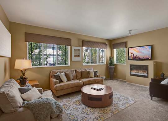 A living room with a couch, coffee table, and a painting on the wall.