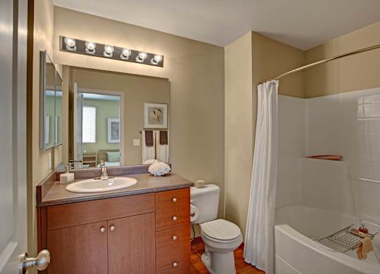 A bathroom with a sink, toilet, and bathtub.