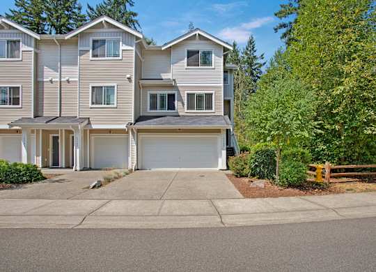 A large, multi-story residential building with a driveway in front.