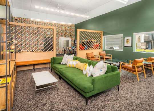 A living room with a green couch and a wooden coffee table.