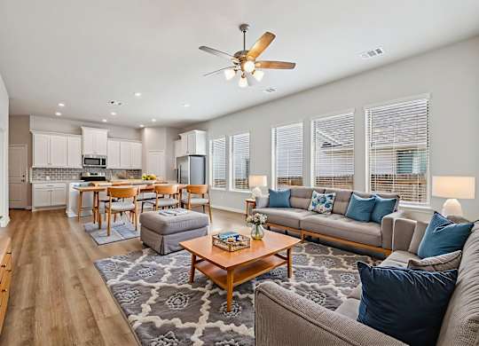 A living room with a grey couch and a wooden coffee table.