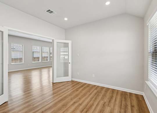 A room with wooden floors and white walls.