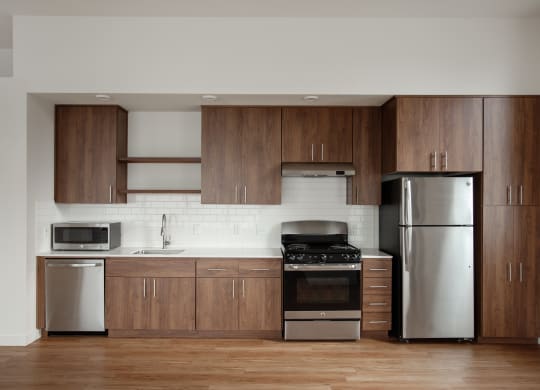 a kitchen with wooden cabinets and stainless steel appliances