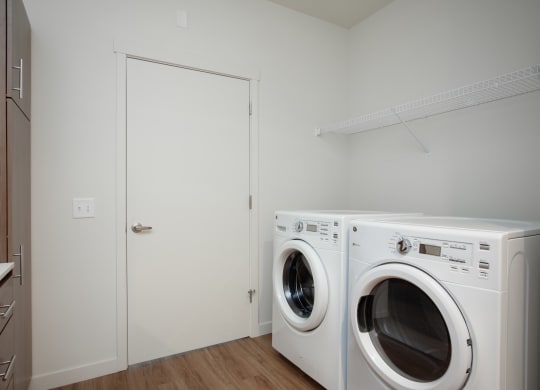 a washer and dryer in a laundry room with a white door
