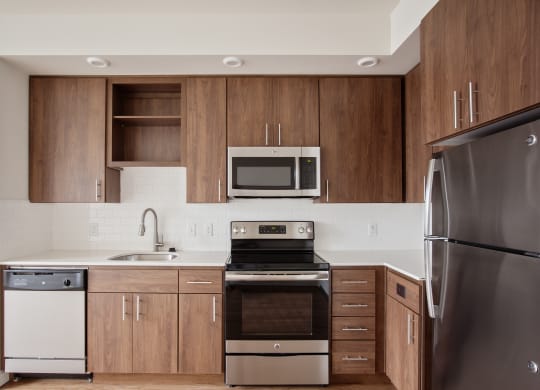 a kitchen with stainless steel appliances and wooden cabinets