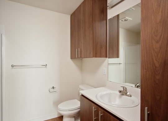 an empty bathroom with a sink toilet and mirror