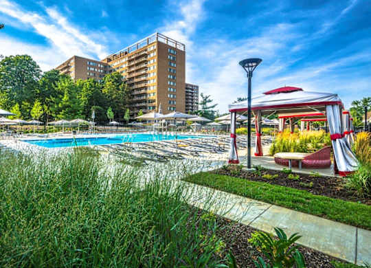 A pool area with a red and white canopy structure.