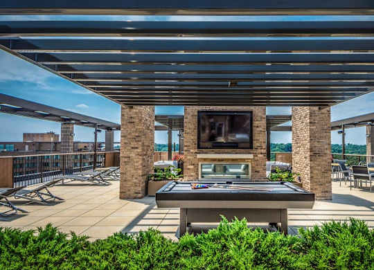 A rooftop with ping pong and seating