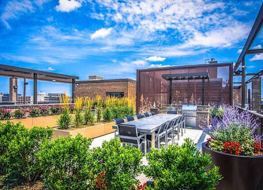 A patio with a table and chairs overlooks a cityscape.