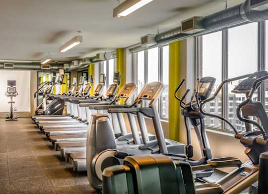 A fitness center with cardio equipment