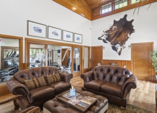 a large living room with leather couches and a coffee table