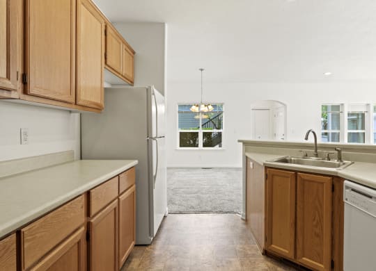 a kitchen with wooden cabinets and white appliances