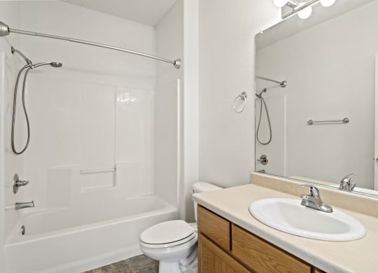 a bathroom with a toilet sink and shower