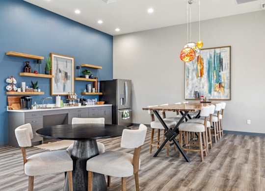 A modern kitchen with a dining table and chairs.