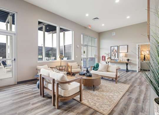 A living room with a white couch and a wooden coffee table.