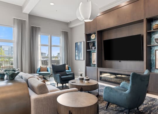 a living room with couches and chairs and a television