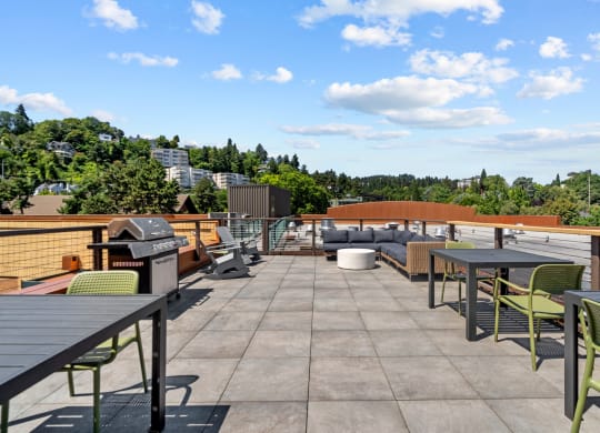 Rooftop deck with grill and picnic area at Collins Circle apartments in the Goose Hollow district in Portland, Oregon.