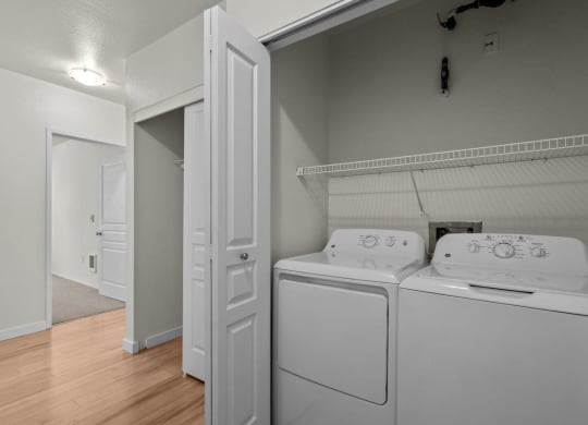 In-unit laundry with washer and dryer machine at Collins Circle apartments in the Goose Hollow district in Portland, Oregon.
