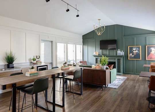 A modern kitchen with a wooden table and chairs.