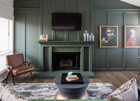 A living room with a fireplace and a chair.