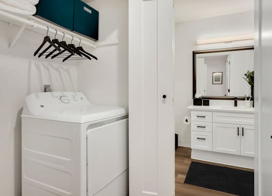 A white washing machine and dryer in a laundry room.