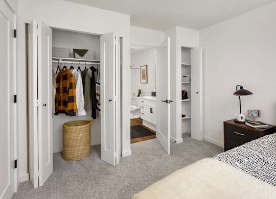 A bedroom with a bed, a wardrobe, and a desk.