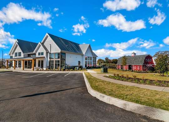 A large building with a parking lot in front of it.