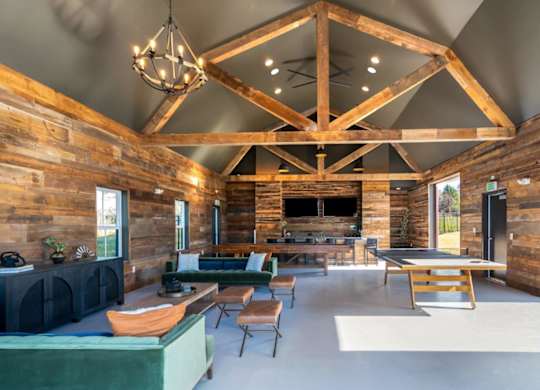 A wooden log cabin interior with a large open floor plan.