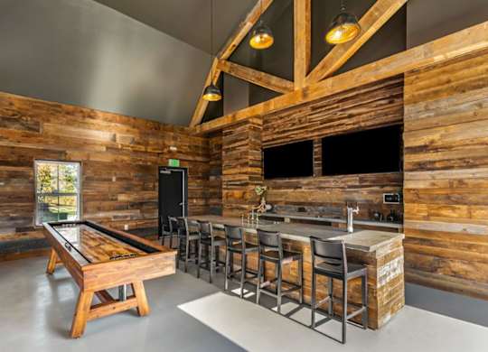 A room with wooden walls and a pool table.
